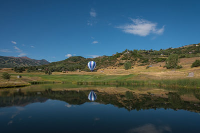 Scenic view of lake against blue sky