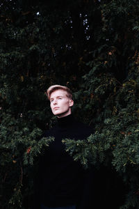 Low angle view of young man in forest