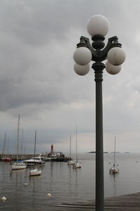 Sailboats in sea against sky