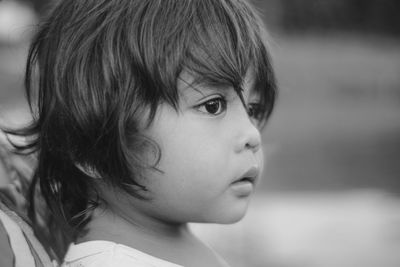 Close-up portrait of cute girl looking away