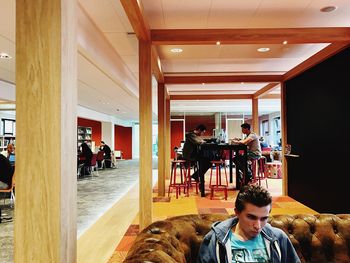 Man looking through window