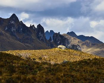 Scenic view of mountains against cloudy sky