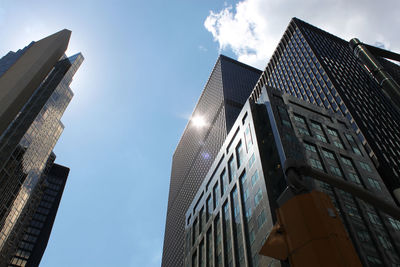 Low angle view of modern buildings against sky in city