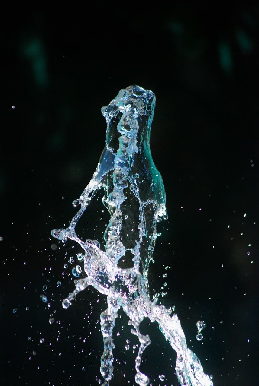 WATER SPLASHING AGAINST BLACK BACKGROUND