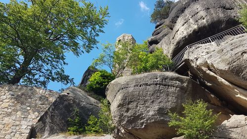 Low angle view of rock formation against sky