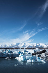 Scenic view of frozen lake against sky during winter