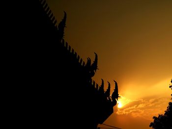 Low angle view of silhouette temple against sky during sunset