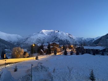 Scenic view of snowcapped mountains against clear blue sky