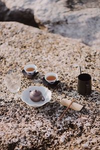 High angle view of coffee cup on sand