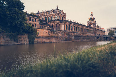 View of bridge over river against buildings