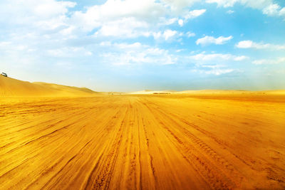 Scenic view of arid landscape against sky