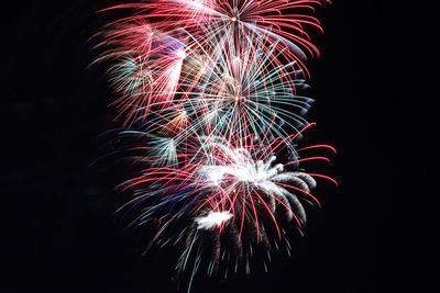 Low angle view of firework display against sky at night