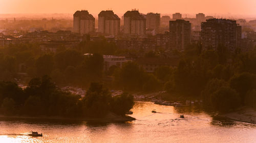 Buildings in city at sunset