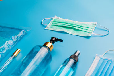 High angle view of bottle on blue table