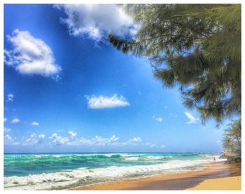 Scenic view of beach against cloudy sky