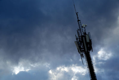 Low angle view of communications tower against sky