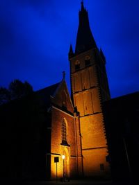 Low angle view of bell tower against sky at night