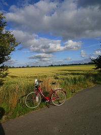 Bicycle on field against sky