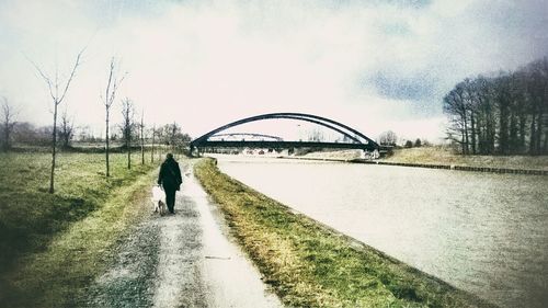 Woman walking on footpath