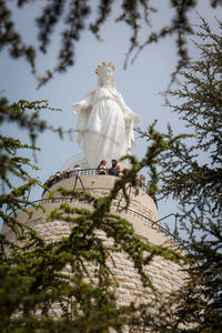 Low angle view of statue against trees