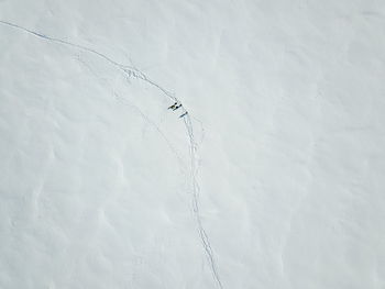 High angle view of snow covered field by mountain