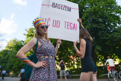 Woman standing against multi colored tree