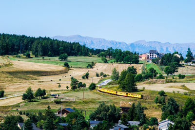 Scenic view of trees and buildings against sky