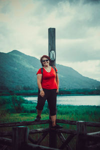 Full length of man standing on mountain against sky