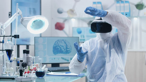 Scientist wearing vr working in laboratory