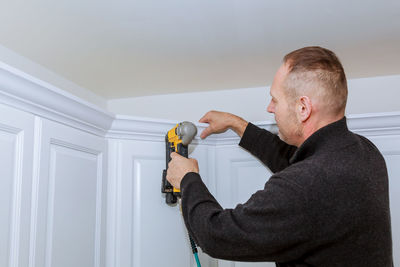 Man working on wall at home