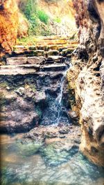 Water flowing through rocks in forest