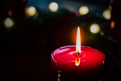 Close-up of illuminated candle against blurred background