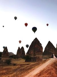 Hot air balloons flying over land