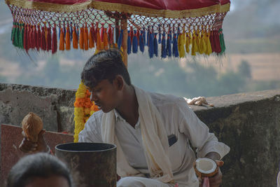 Young man holding coconut