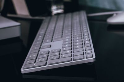 Close-up of gray keyboard on black desk