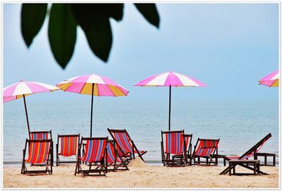 Deck chair and umbrella at beach