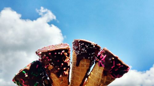 Close-up of ice creams against blue sky