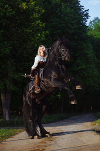 Portrait of young woman riding horse