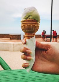 Hand holding ice cream cone