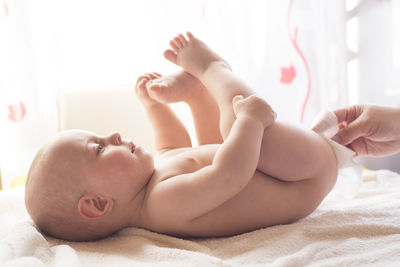 Cute baby lying on bed