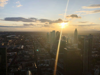 Aerial view of buildings in city during sunset