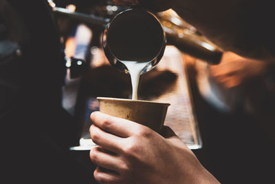 Midsection of man holding coffee cup