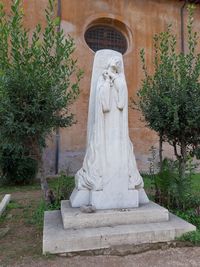 Statue against trees and plants