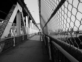 Footbridge in city against sky