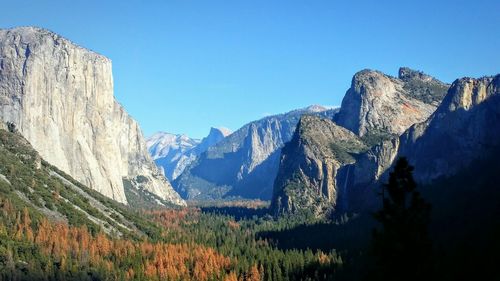 Low angle view of mountains against blue sky