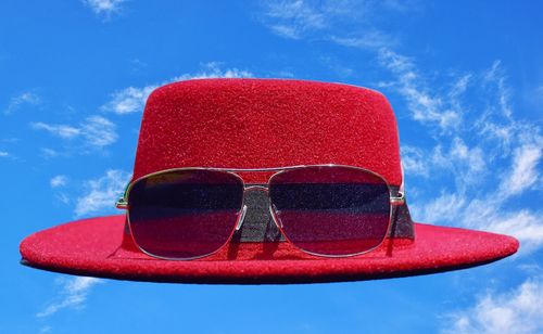 Close-up of sunglasses against blue sky