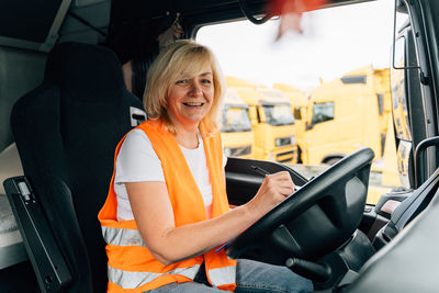 Mature woman sitting in truck