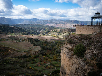 Scenic view of building and mountains against sky