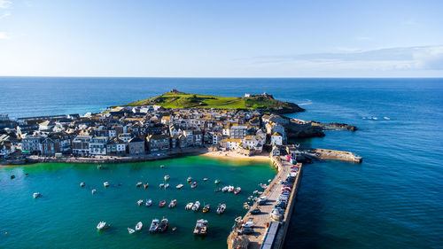 High angle view of buildings by sea against sky