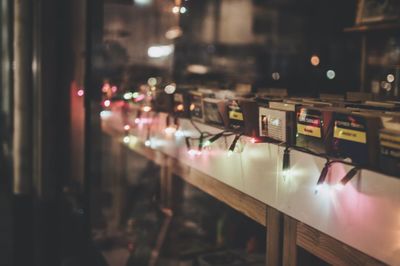 Illuminated lighting equipment on shelf at night